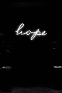 Black and white image of a neon sign displaying the word 'hope' in cursive.