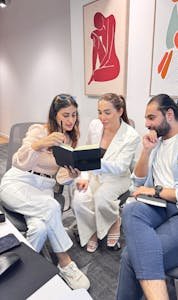 A diverse group of professionals engaged in a productive team meeting in a modern office setting.