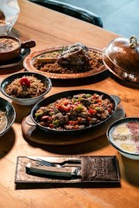 A Middle Eastern culinary spread with flavorful rice and meat dishes, perfect for food enthusiasts.